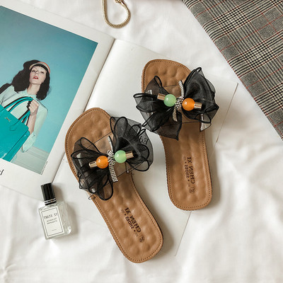 Női papucs lapos talppal és pecsétszalaggal