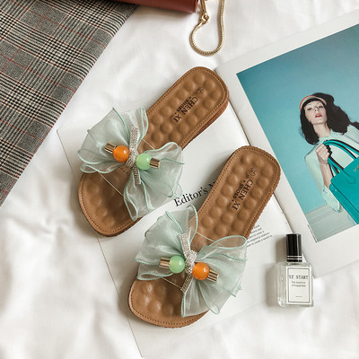 Női papucs lapos talppal és pecsétszalaggal