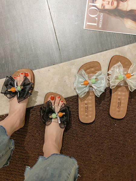 Női papucs lapos talppal és pecsétszalaggal