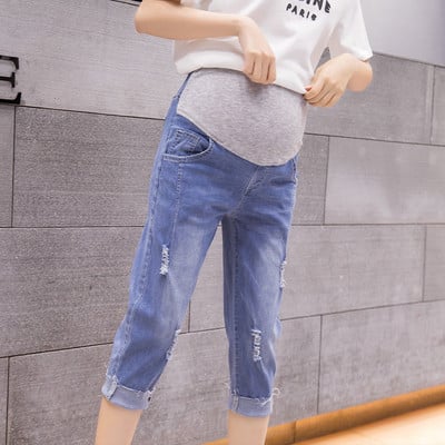 Laisvalaikio džinsai nėščiosioms su 3/4 ilgio ir suplyšusiais motyvais