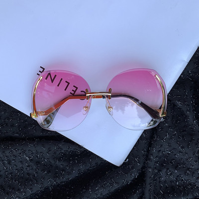 Γυναικεία μοντέρνα γυαλιά ηλίου με στρογγυλούς φακούς και λεπτά κουφώματα