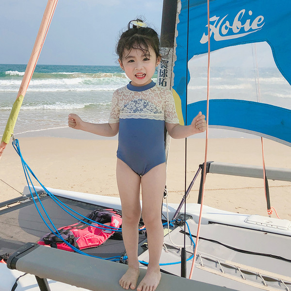 Stílusos fürdőruha lányoknak rövid ujjal és csipkével