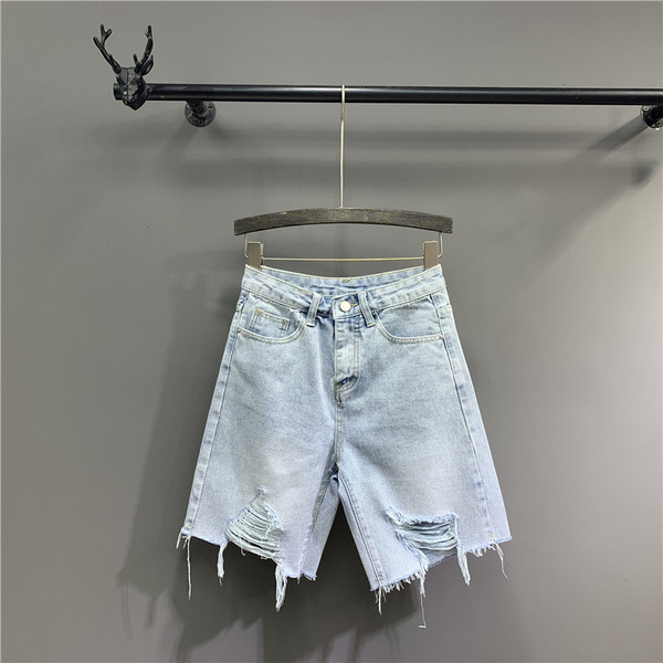 Női farmer szakadt motívumokkal, kék színben