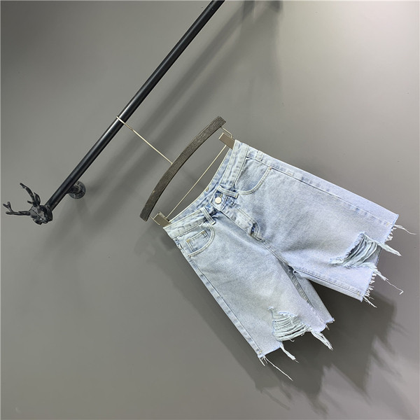 Női farmer szakadt motívumokkal, kék színben