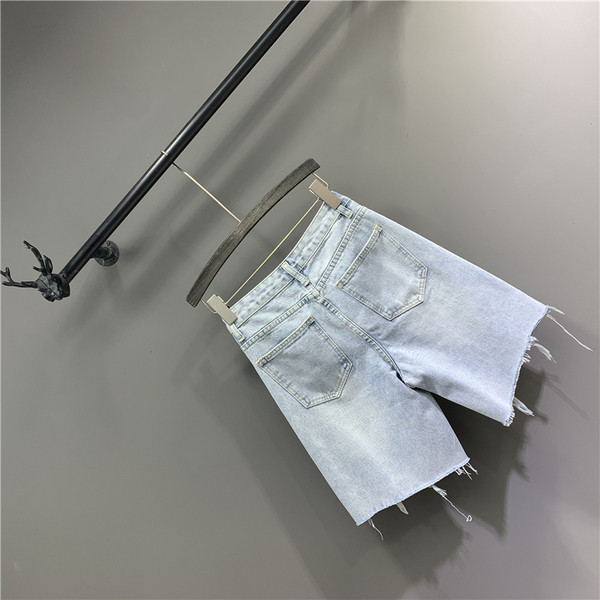 Női farmer szakadt motívumokkal, kék színben