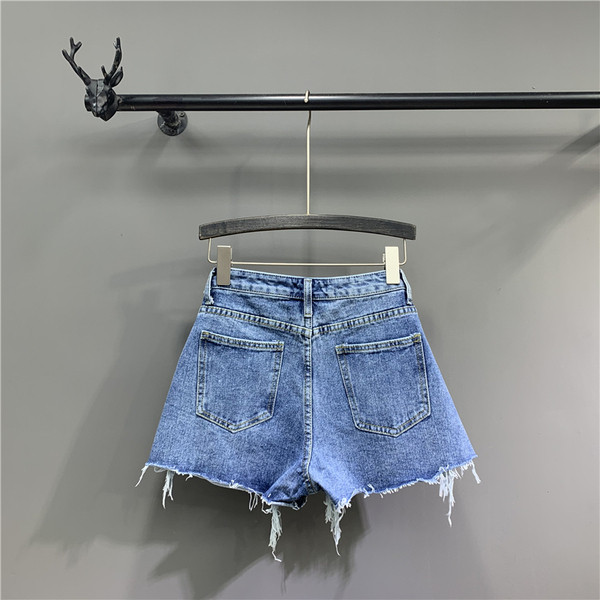 Moodsad sinist värvi rebenenud elementidega naiste lühikesed püksid