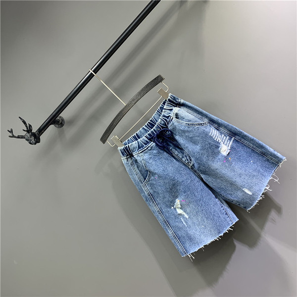 Lezser női 3/4-es nadrág szakadt motívumokkal, kék színben