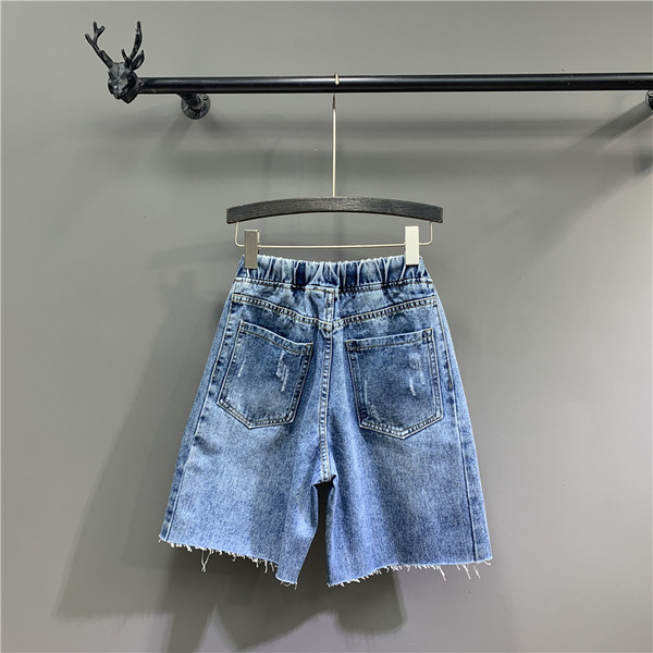 Lezser női 3/4-es nadrág szakadt motívumokkal, kék színben