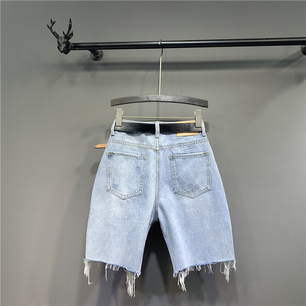 Új női farmer modell szakadt elemekkel és övvel