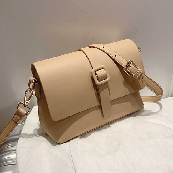 Fém rögzítéssel és műbőr fogantyúval ellátott női táska