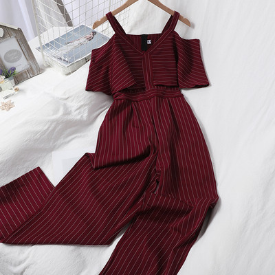 Dugi ženski kombinezon s kovrčama i golim ramenima