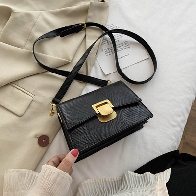 Moderna ženska kožna torba s metalnim kopčanjem i dugom ručkom