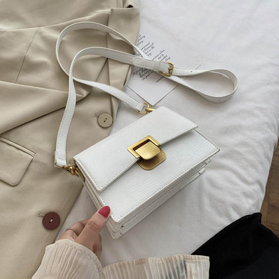 Moderna ženska kožna torba s metalnim kopčanjem i dugom ručkom