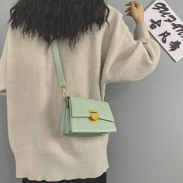 Moderna ženska kožna torba s metalnim kopčanjem i dugom ručkom