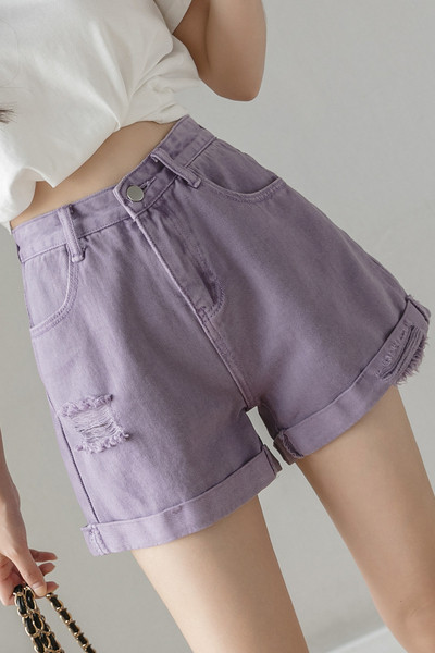 Női farmer szakadt motívumokkal