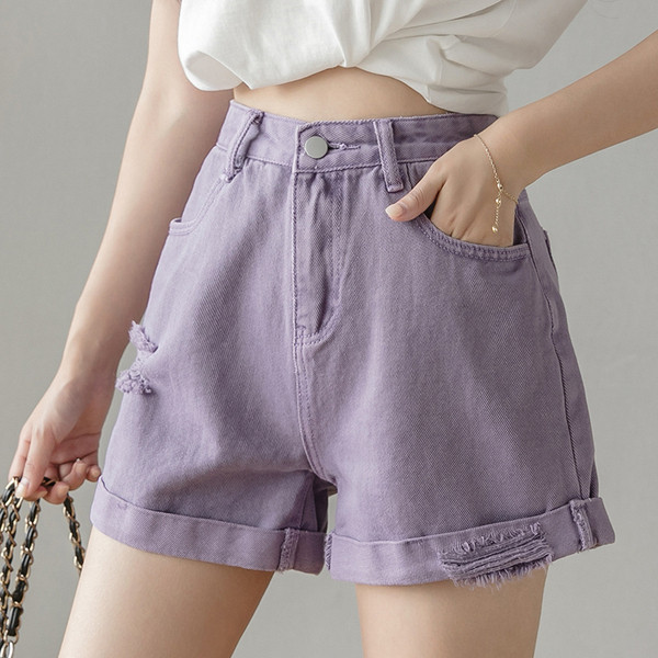 Női farmer szakadt motívumokkal