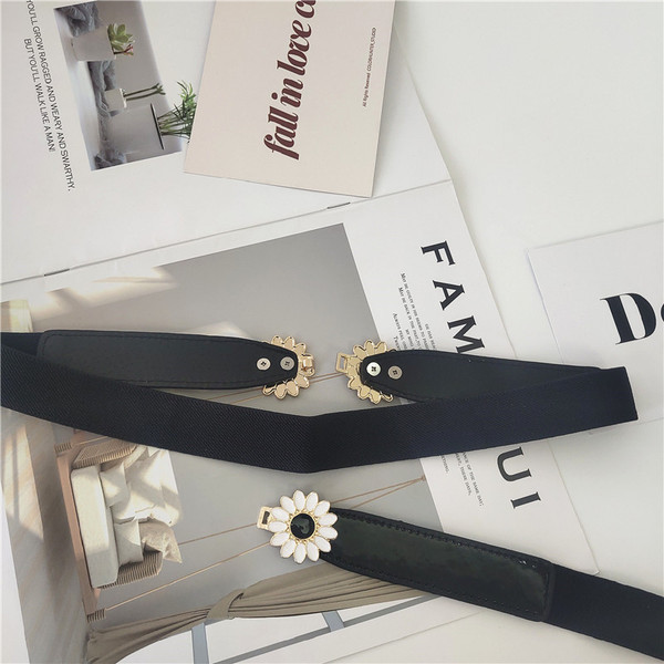 Vékony női elasztikus öv fém elemes virágokkal