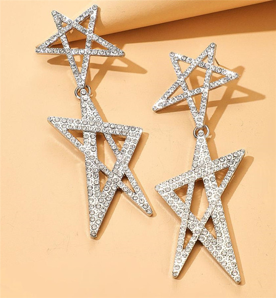 Női lógó fülbevaló arany színű és csillag alakú kövekkel