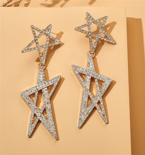 Női lógó fülbevaló arany színű és csillag alakú kövekkel