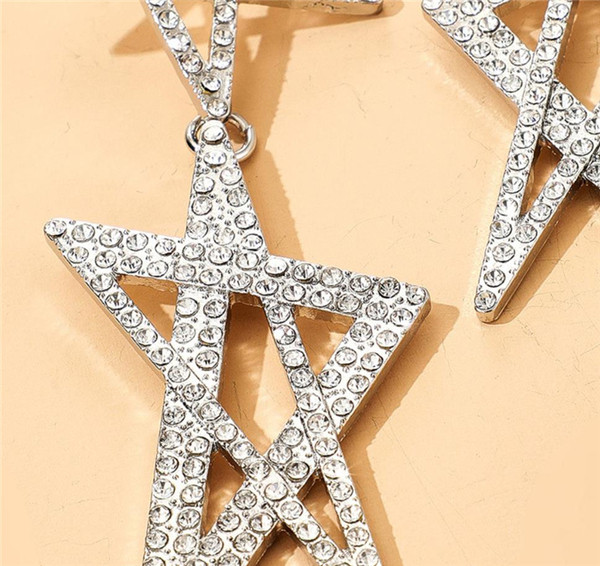 Női lógó fülbevaló arany színű és csillag alakú kövekkel