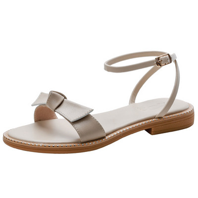 Γυναικεία σανδάλια από οικολογικό δέρμα με κορδέλα και επίπεδη σόλα σε μπεζ χρώμα