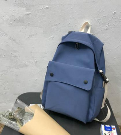 Női textil hátizsák nagy első zsebbel