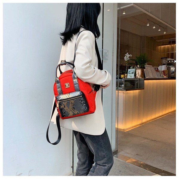 Modern női hátizsák elülső zsebbel, kígyómintával