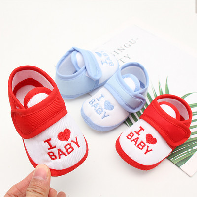 Baby shoes with inscription and sticker