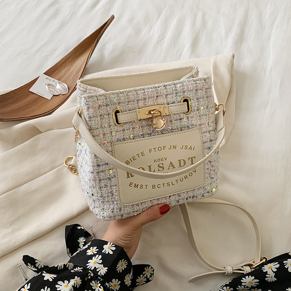 Moderna ženska torba sa natpisom i metalnim elementom