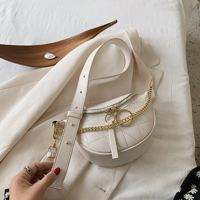 Mala ženska torba sa metalnim elementima i dugom ručkom