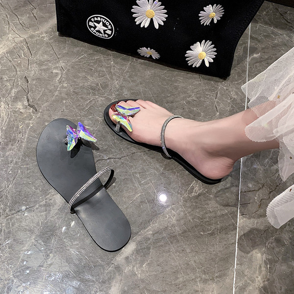 Modern női papucsok a földön keresztül, különböző formájú kövekkel