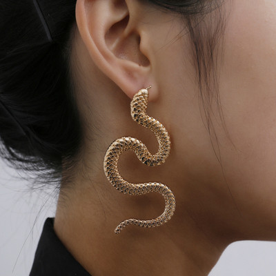 New model of women`s earrings in the shape of a snake