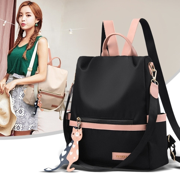 Kényelmes női hátizsák elülső zsebbel és kiegészítővel