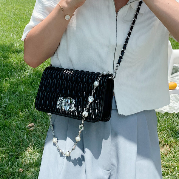 Γυναικεία μοντέρνα μικρή τσάντα με μεταλλική λαβή και πέρλες