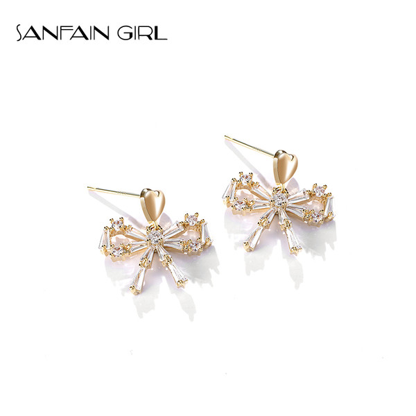 Egyszerű női fülbevaló kövekkel díszített szalag formájú