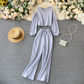 Naiste vabaaja komplekt, mis sisaldab paljaste õlgadega pluusi ja laia pükse