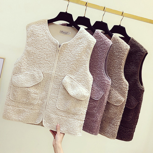 Női pehelymellény cipzárral és zsebekkel