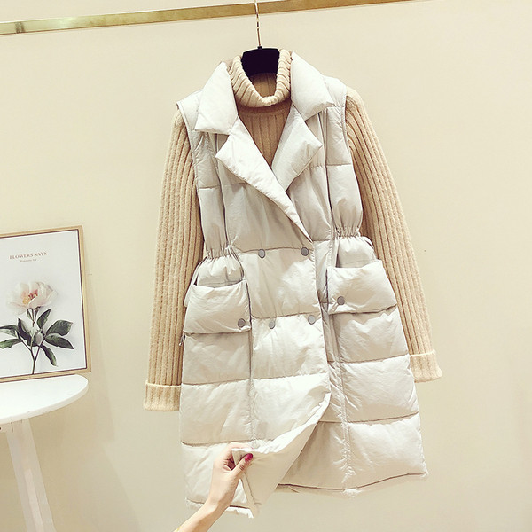 Hosszú női mellény cipzárral és zsebekkel