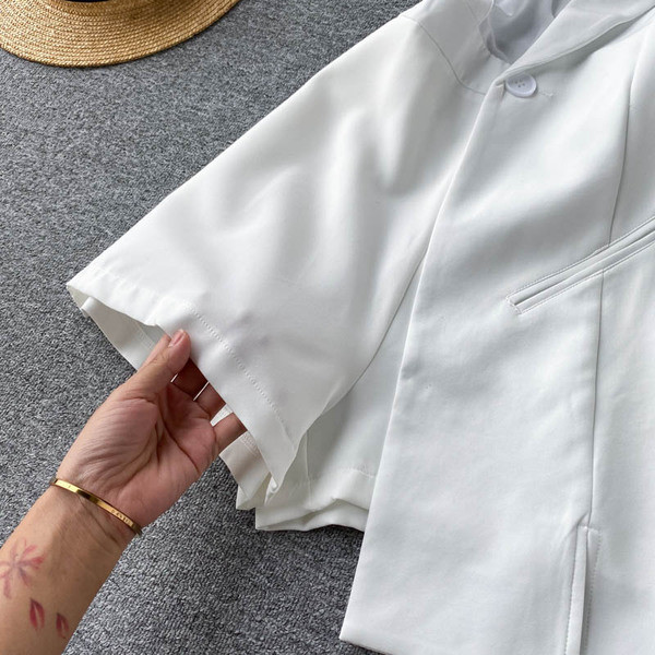 Női aszimmetrikus jumpsuit gombbal