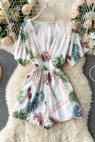 Balts sieviešu kombinezons ar ziedu apdruku un špica kakla izgriezumu