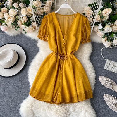 Modern női overall spitz nyakkivágással és nyakkendővel