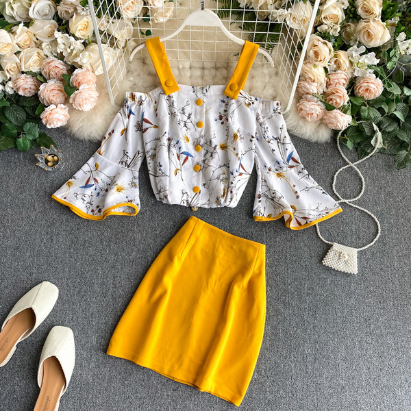 Naiste paljaste õlgadega pluusi ja kõrge vöökohaga seelikuga kollane