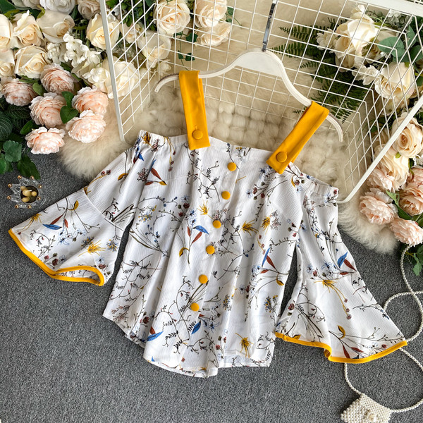 Naiste paljaste õlgadega pluusi ja kõrge vöökohaga seelikuga kollane