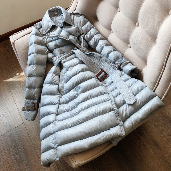 Pikk naiste veekindel jope vööga